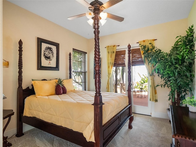 carpeted bedroom with a ceiling fan, access to outside, multiple windows, and baseboards