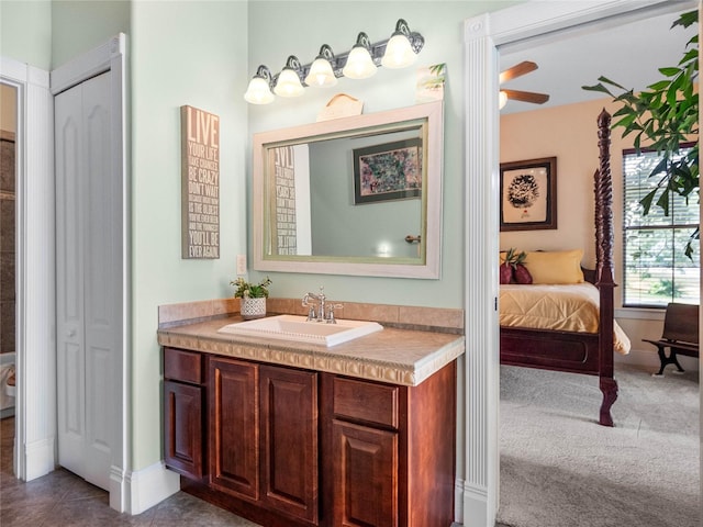 bathroom featuring ensuite bathroom, a closet, and vanity