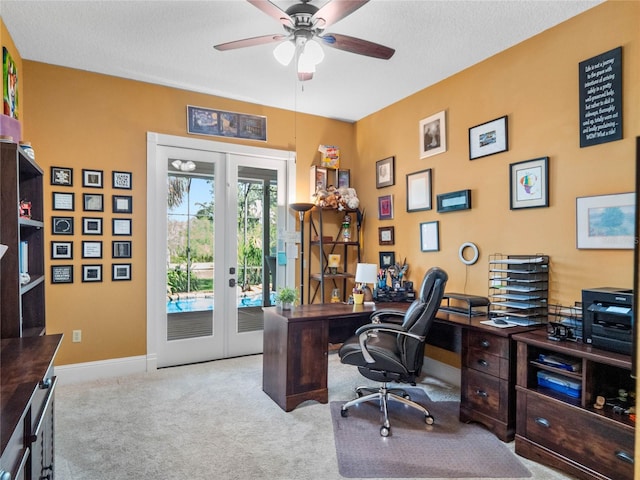 office with baseboards, light colored carpet, ceiling fan, a textured ceiling, and french doors