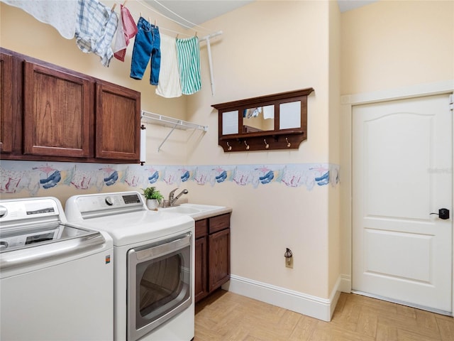 laundry room featuring a sink, cabinet space, and washer and dryer