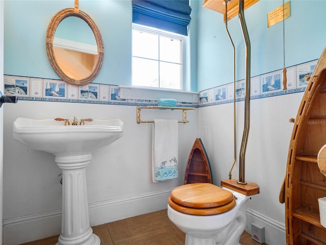 bathroom with baseboards and toilet