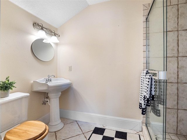 full bath with lofted ceiling, tile patterned flooring, toilet, baseboards, and a shower stall