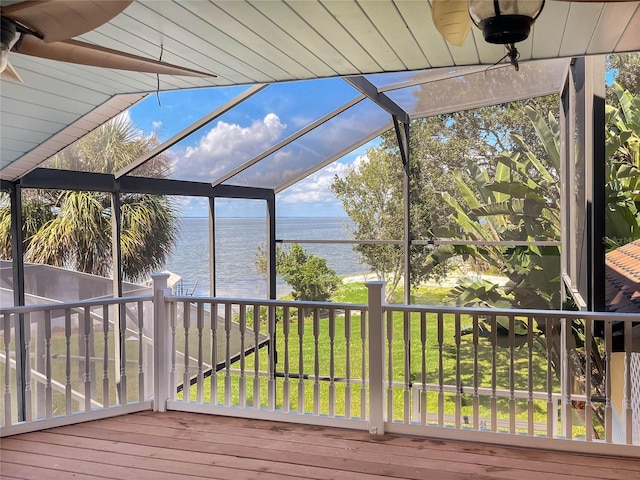 unfurnished sunroom featuring a water view