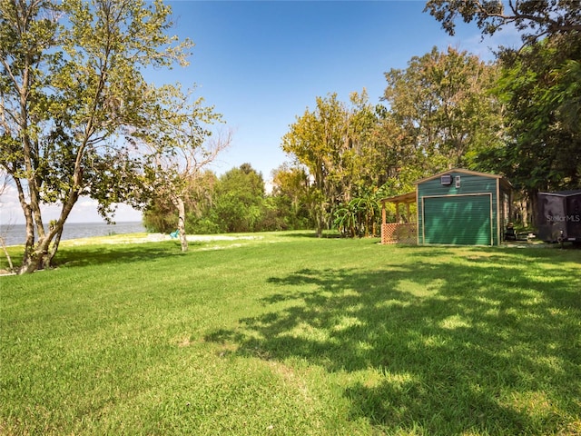 view of yard with an outdoor structure and a water view