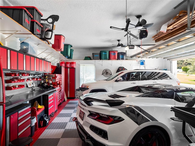 garage with a garage door opener and ceiling fan