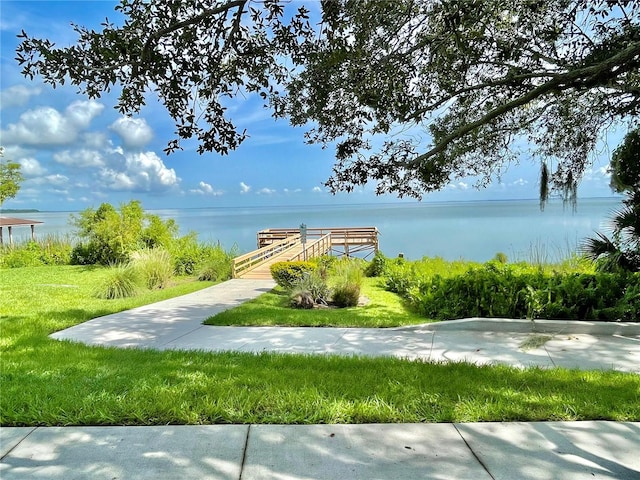 view of home's community featuring a yard and a water view