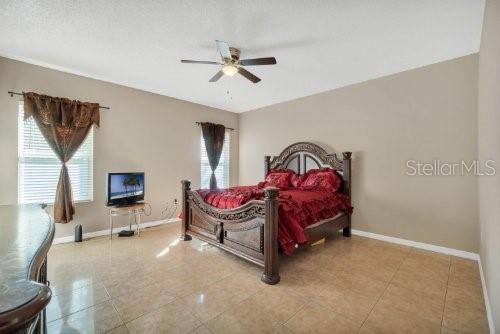 tiled bedroom with ceiling fan