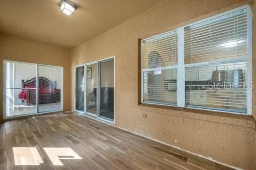 unfurnished room with wood finished floors