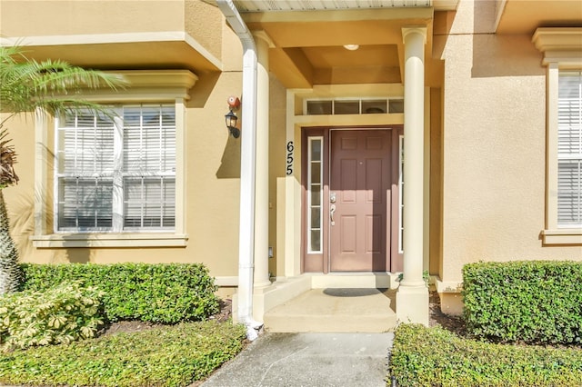 entrance to property with stucco siding