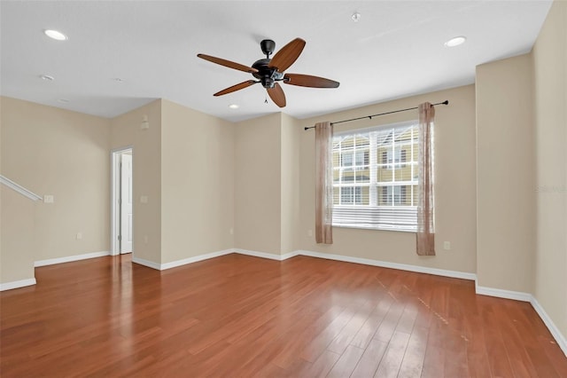 unfurnished room featuring baseboards, ceiling fan, wood finished floors, and recessed lighting