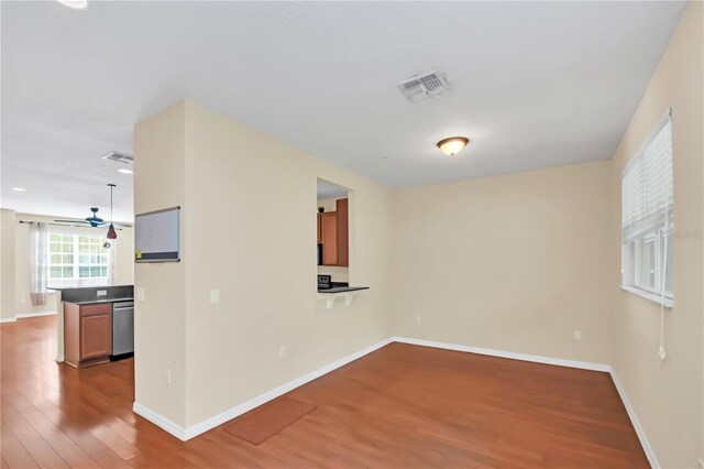 unfurnished room with ceiling fan and hardwood / wood-style flooring