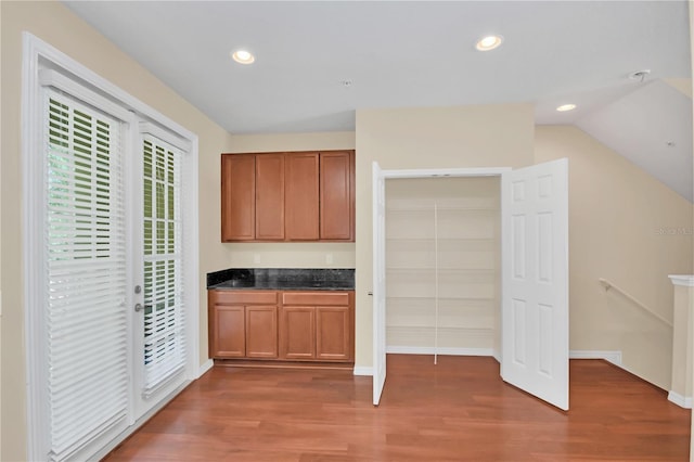 kitchen with lofted ceiling and dark wood-type flooring