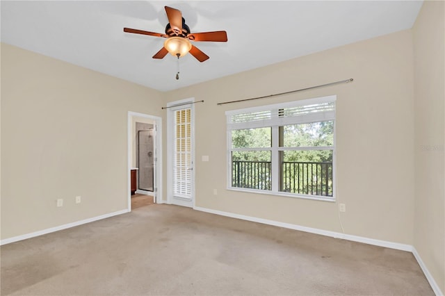 carpeted empty room featuring ceiling fan