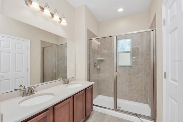 bathroom with double vanity, a sink, and a shower stall