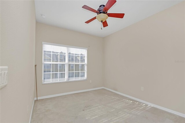 unfurnished room featuring ceiling fan and light colored carpet