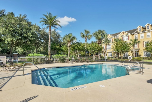 view of pool featuring fence and a patio