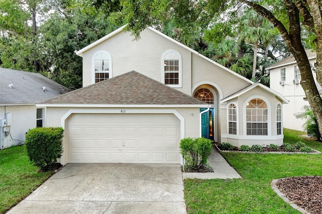 view of front of house featuring a garage and a front lawn