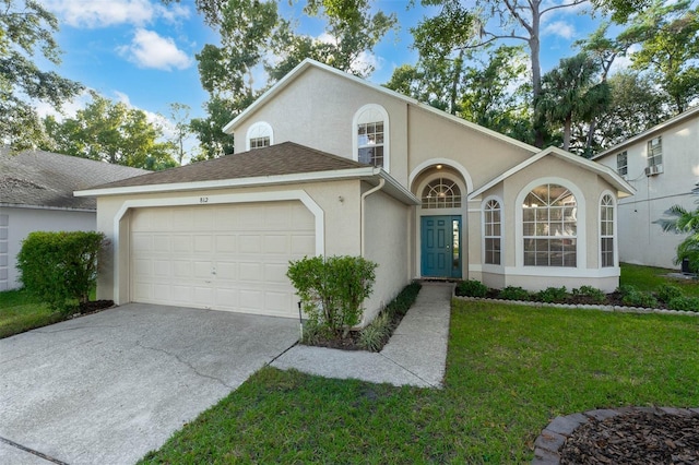 view of front of home with a front lawn and a garage