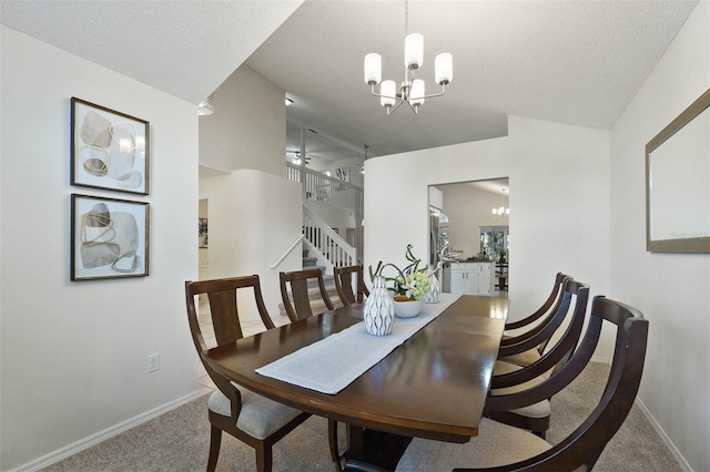 carpeted dining area with a textured ceiling and a notable chandelier