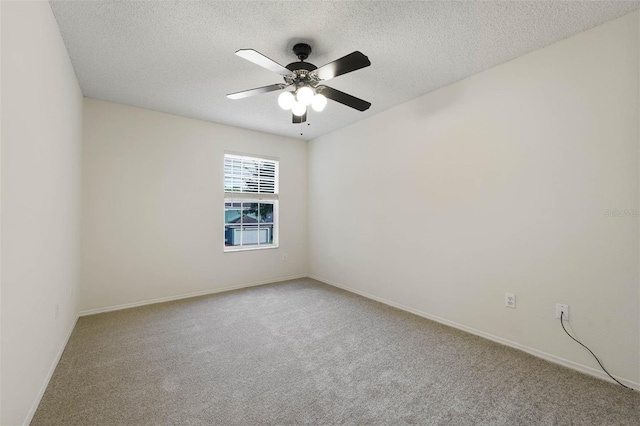 carpeted spare room featuring a textured ceiling and ceiling fan