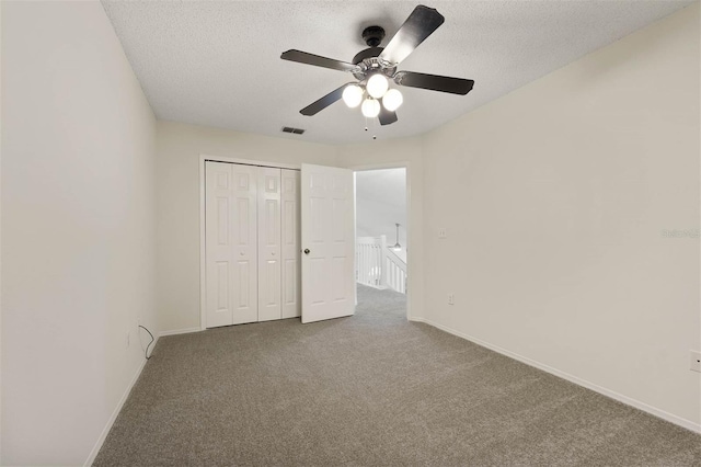 unfurnished bedroom featuring a closet, carpet flooring, and ceiling fan