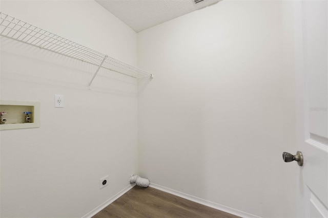 laundry area featuring dark hardwood / wood-style flooring, electric dryer hookup, and washer hookup