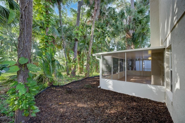 view of yard featuring a sunroom