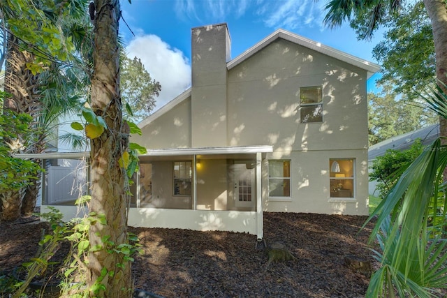 rear view of house featuring a sunroom