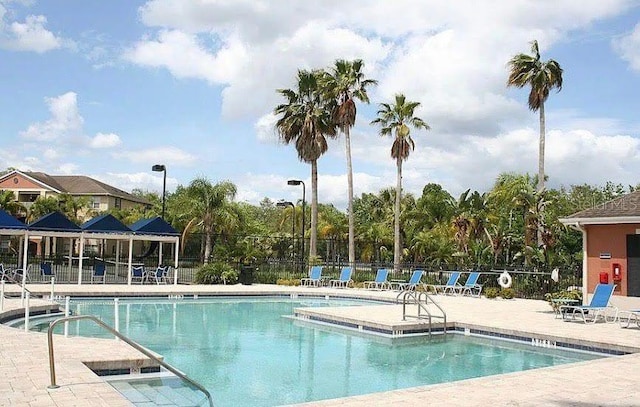 1909 Summer Club Dr Unit 307, Oviedo, FL 32765 - community pool with a patio and fence