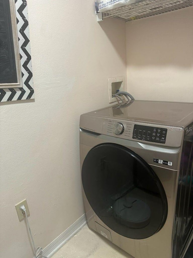 1909 Summer Club Dr Unit 307, Oviedo, FL 32765 - clothes washing area with baseboards, washer / clothes dryer, and laundry area