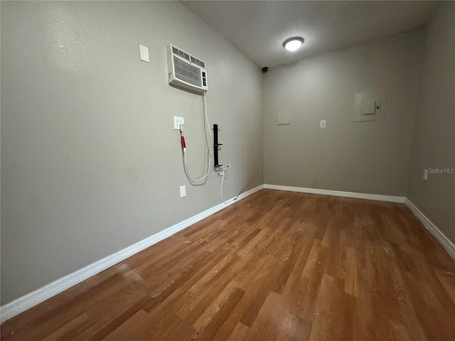 interior space with wood-type flooring and a wall mounted AC