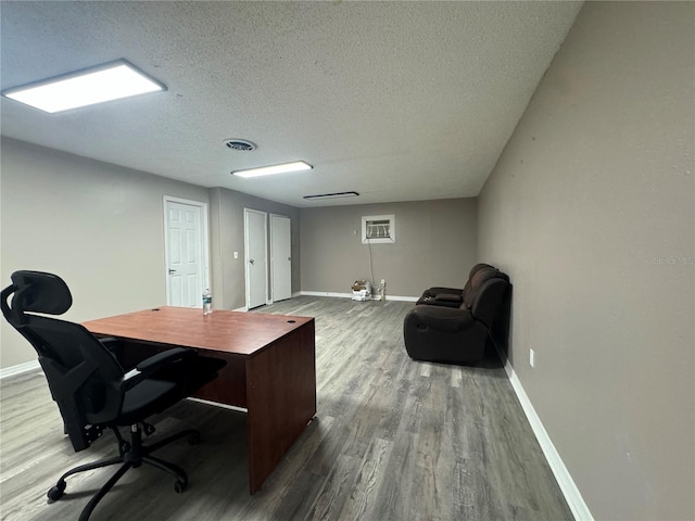 home office with a textured ceiling and wood-type flooring