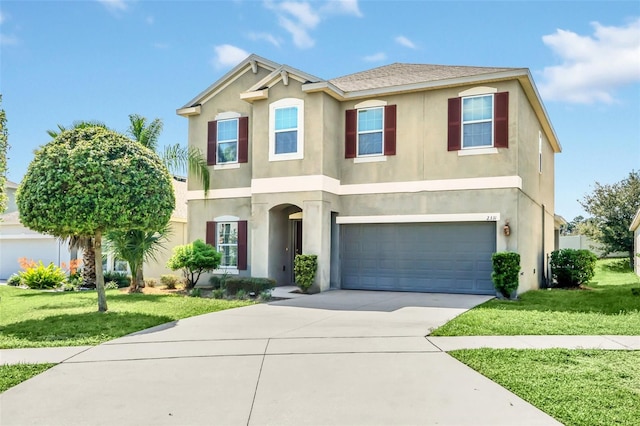 view of front of property featuring a front lawn and a garage