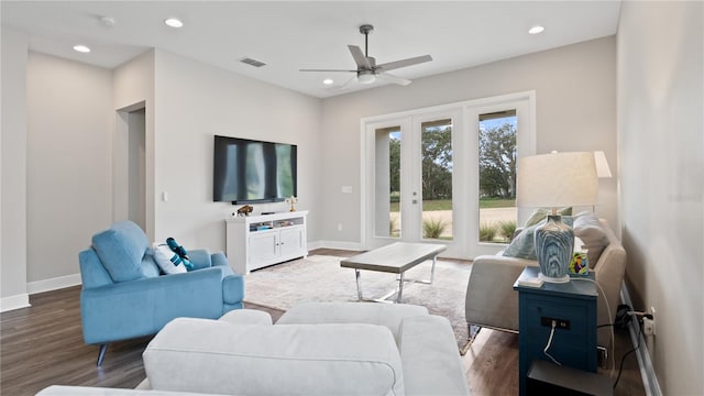 living room with ceiling fan and dark wood-type flooring