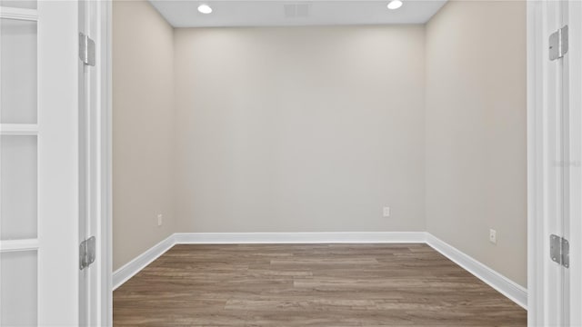 empty room with hardwood / wood-style floors