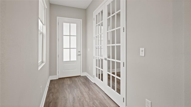 doorway with light wood-type flooring and french doors