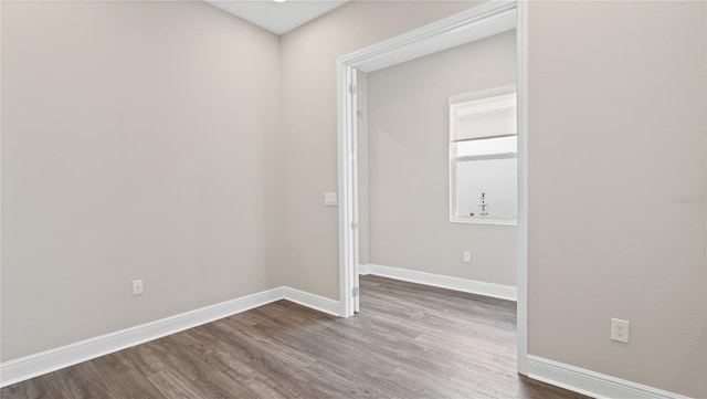 spare room with wood-type flooring