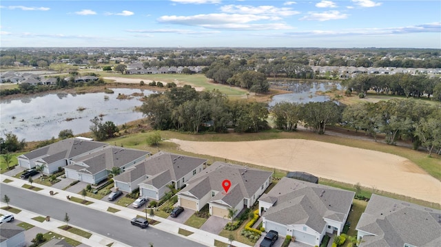 birds eye view of property with a water view