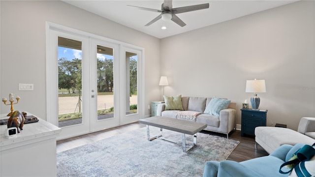 living room with ceiling fan and dark hardwood / wood-style flooring