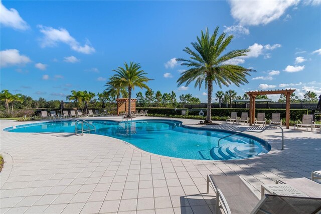 view of pool with a patio and a pergola