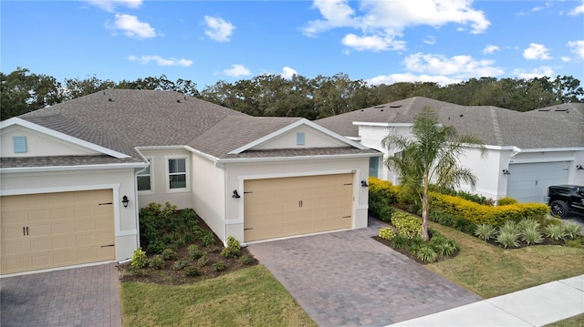 single story home with a front yard and a garage