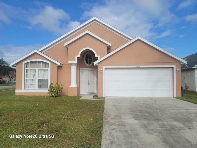 single story home with a front yard and a garage