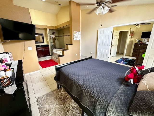 bedroom featuring ensuite bath, ceiling fan, high vaulted ceiling, and light tile patterned floors