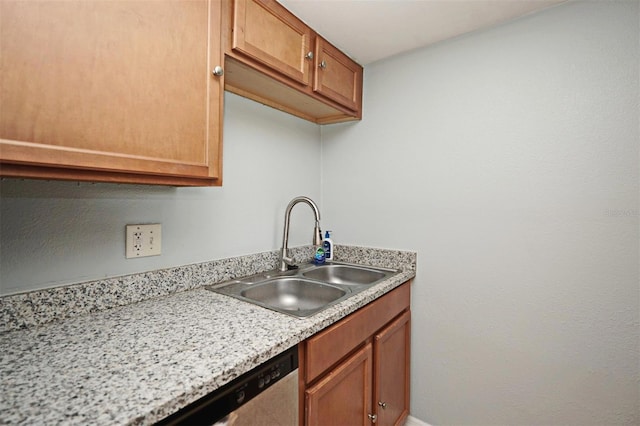 kitchen with light stone countertops and sink