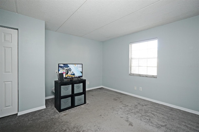 unfurnished room with baseboards, carpet flooring, and a textured ceiling