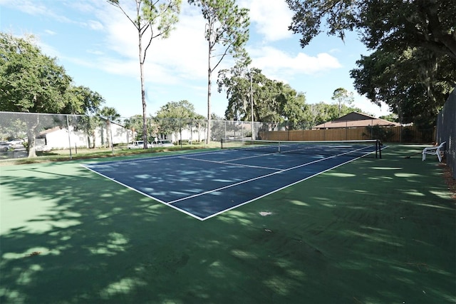 view of sport court featuring fence