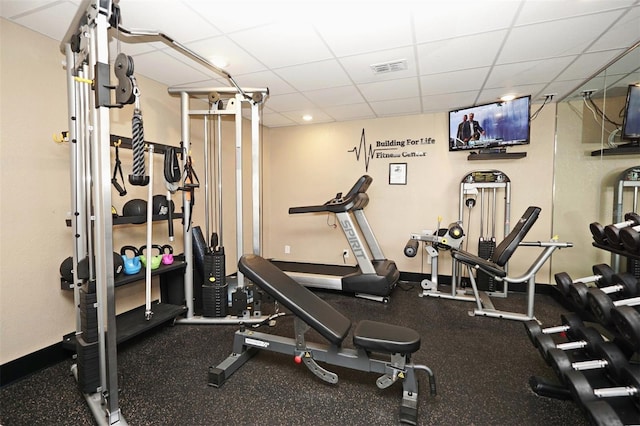 exercise room featuring visible vents and a paneled ceiling