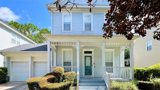 view of front of property featuring a porch and a garage