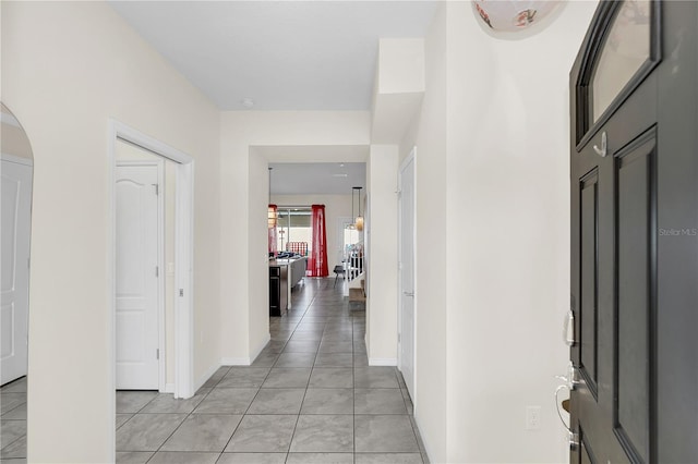 hall featuring light tile patterned flooring