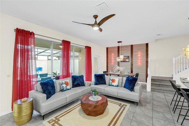 living room featuring ceiling fan and light tile patterned flooring